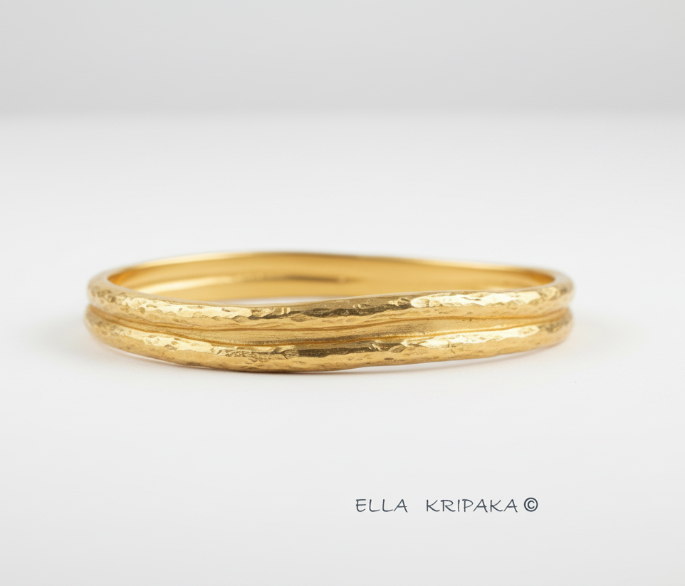 Organic 24k gold 9999 gold hammered bangle thick bracelet with uneven edges on a white background, name of artist-jeweler 'Ella Kripaka'