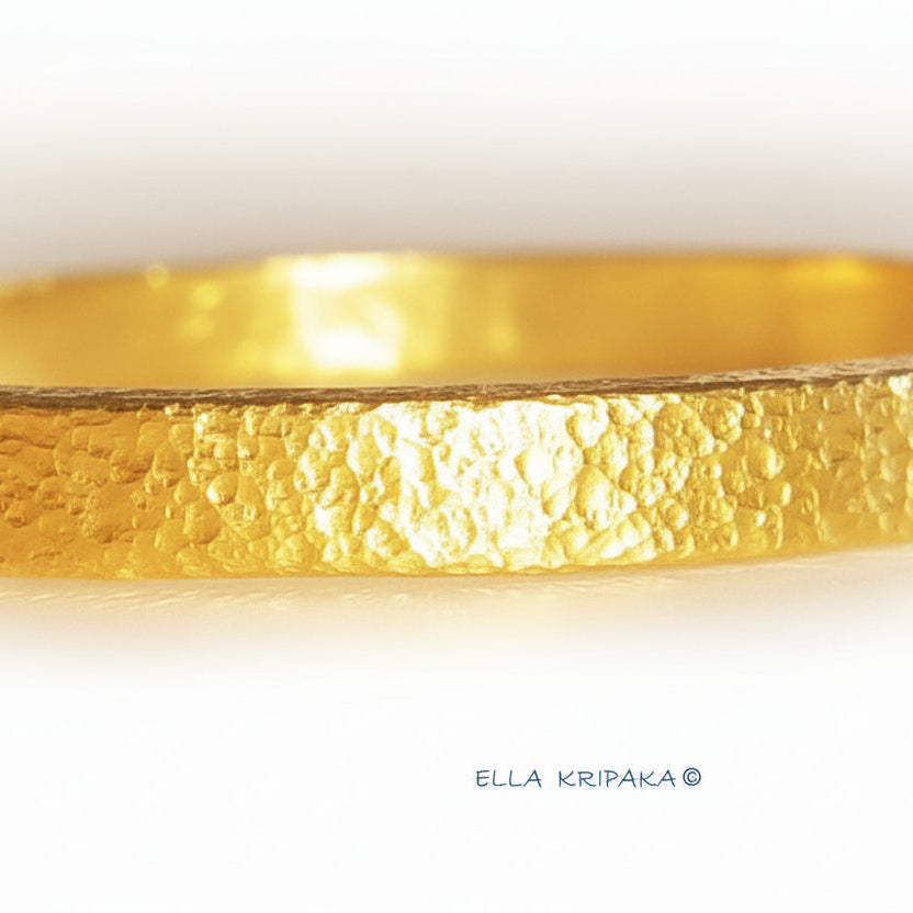 Hammered 24k 9999 gold bangle thick bracelet Ancient Rome style on a white background, artist-jeweler name 'Ella Kripaka' branding