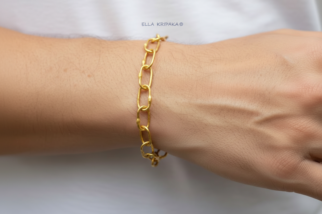 22k gold hammered chain bracelet worn on man's wrist on a white background, artist-jeweler's name 'Ella Kripaka' branding