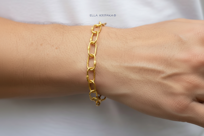 22k gold hammered chain bracelet worn on man's wrist on a white background, artist-jeweler's name 'Ella Kripaka' branding
