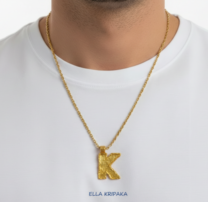 Hammered 24k 9999 Gold necklace with 24k gold organic'K' pendant worn by a person on a white background, artist's name 'Ella Kripaka'