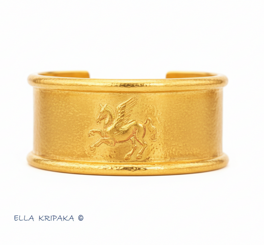 24k 9999 gold hammered Ancient Rome bracelet cuff with convex Pegasus on white background, indicating it is a custom-made jewelry with creator's name 'Ella Kripaka'