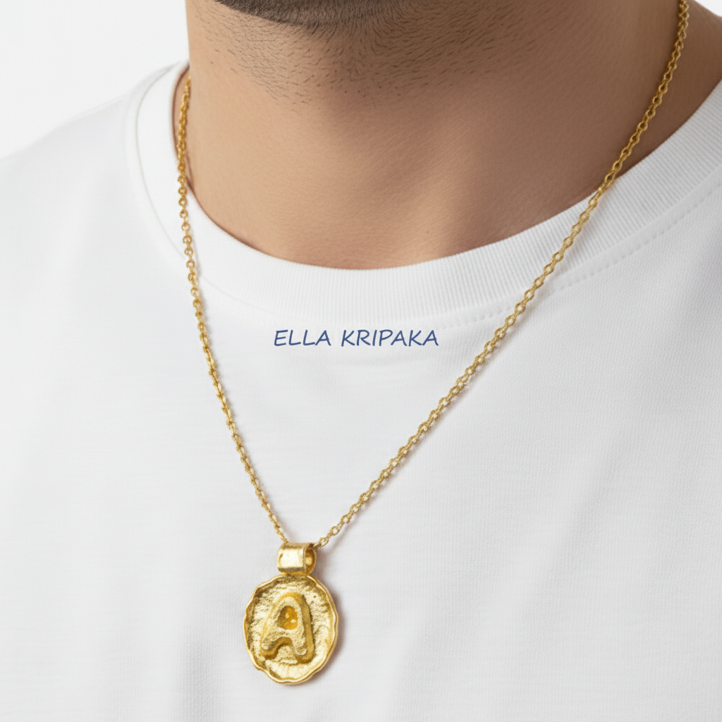 Hammered 24k 9999 gold Organic pendant with Initsl 'A' on chain wearing on man with white t-shirt background, branding artist name 'Ella Kripaka'