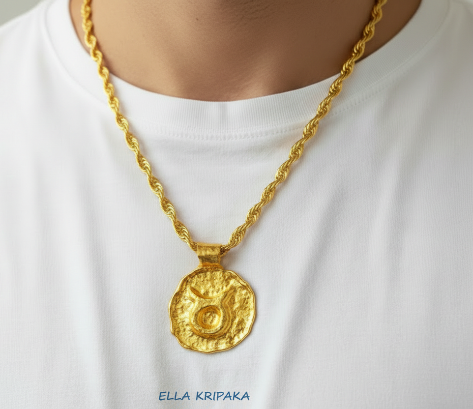 Hammered 24k 9999 gold Organic pendant with Taurus sign on chain wearing on man with white t-shirt background, branding artist name 'Ella Kripaka'