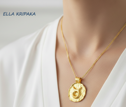 Hammered 24k 9999 gold Organic pendant with Taurus sign on chain wearing on woman with white shirt background, branding artist name 'Ella Kripaka'