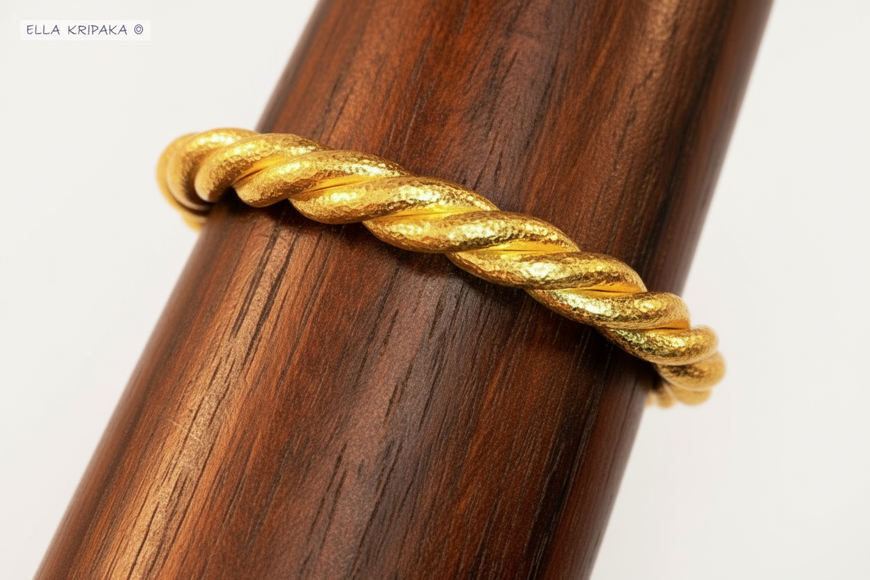 Twisted Viking Hammered 24k 9999 gold bracelet thick cuff on a dark wooden stand and on a white background, branding artist-jeweler name 'Ella Kripaka'