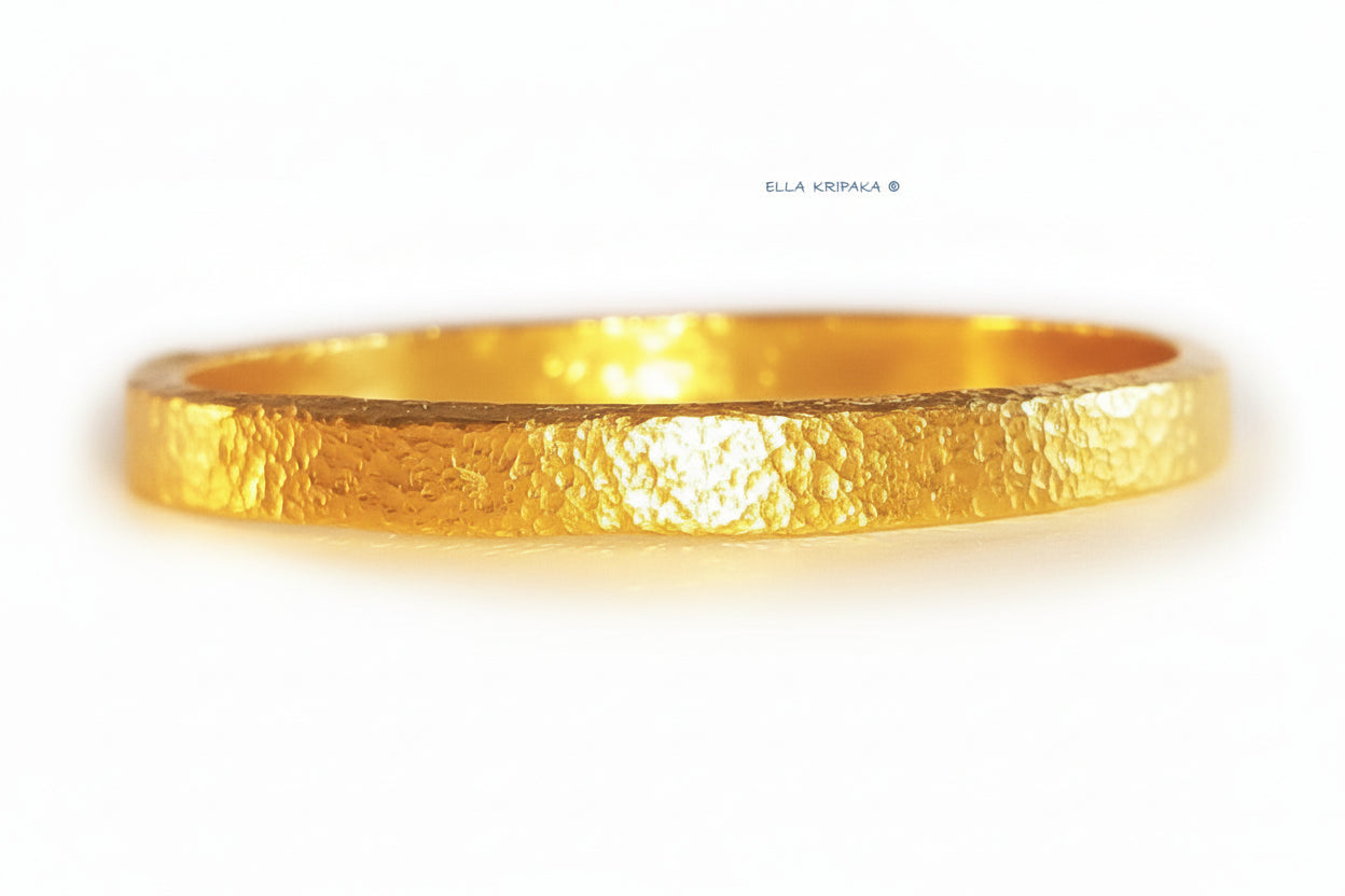 Hammered 24k 9999 gold bangle thick bracelet Ancient Rome style on a white background, artist-jeweler name 'Ella Kripaka' branding
