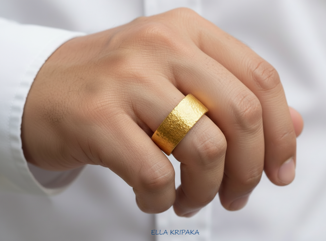 Hammered 24k 9999 Gold thick ring Ancient Rome style with a textured gold on man's finger on blurred white shirt backgroud, branded 'Ella Kripaka' artist-jeweler