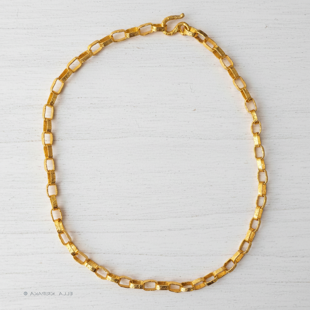 Hammered 24k chain necklace as in Ancient Rome on a white wooden background, branding artist name 'Ella Kripaka'