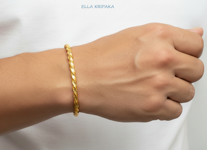 Viking Twisted Hammered 24k 9999 gold cuff thick bracelet worn on a wrist by a man on a white background, artist-jeweler name 'Ella Kripaka' branding