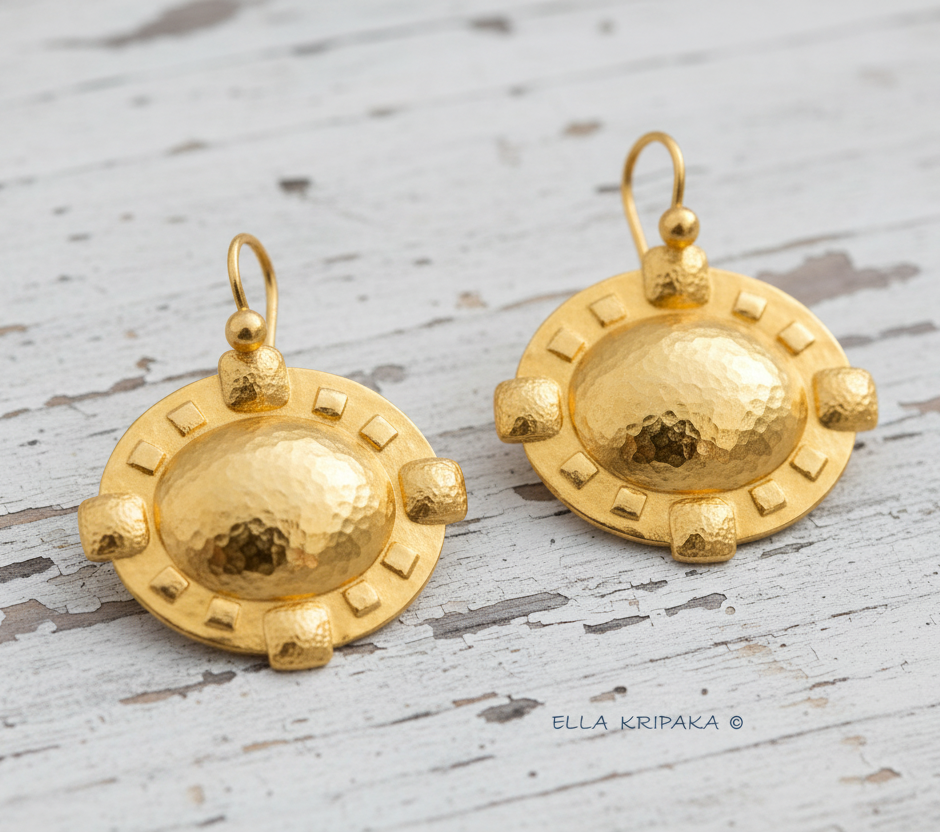 24k 9999 gold hammered Byzantine Cross earrings with forged gold textures is on a old wooden surface, artist's name 'Ella Kripaka'