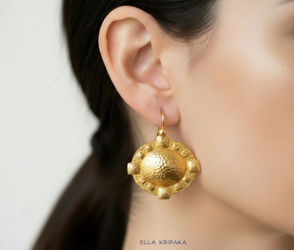 Hammered 24k 9999 Gold Byzantine Dome Earrings on woman's ear, forged pure 24k gold jewelry, artist-jeweler Ella Kripaka