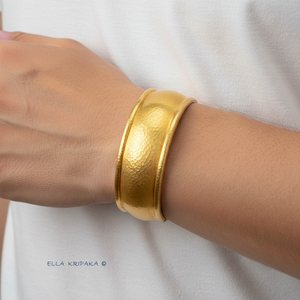 24k 9999 gold hammered convex cuff bracelet on man's wrist on a white background with 'Ella Kripaka' branding.