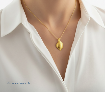 Hammered 24k 9999 Gold Byzantine Pendant wearing on woman's neck with white shirt, forged pure 24k gold jewelry, artist-jeweler's name 'Ella Kripaka'