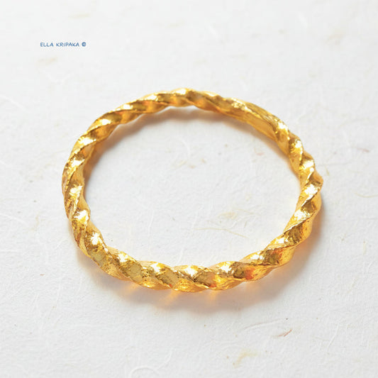 Twisted Viking Hammered 24k 9999 Gold bangle bracelet on white wooden surface, artist's name 'Ella Kripaka' branding