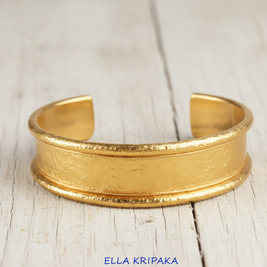 Hammered 24k 9999 gold bracelet cuff Ancient Rome style on a old wooden background, branding artist-jeweler name 'Ella Kripaka'