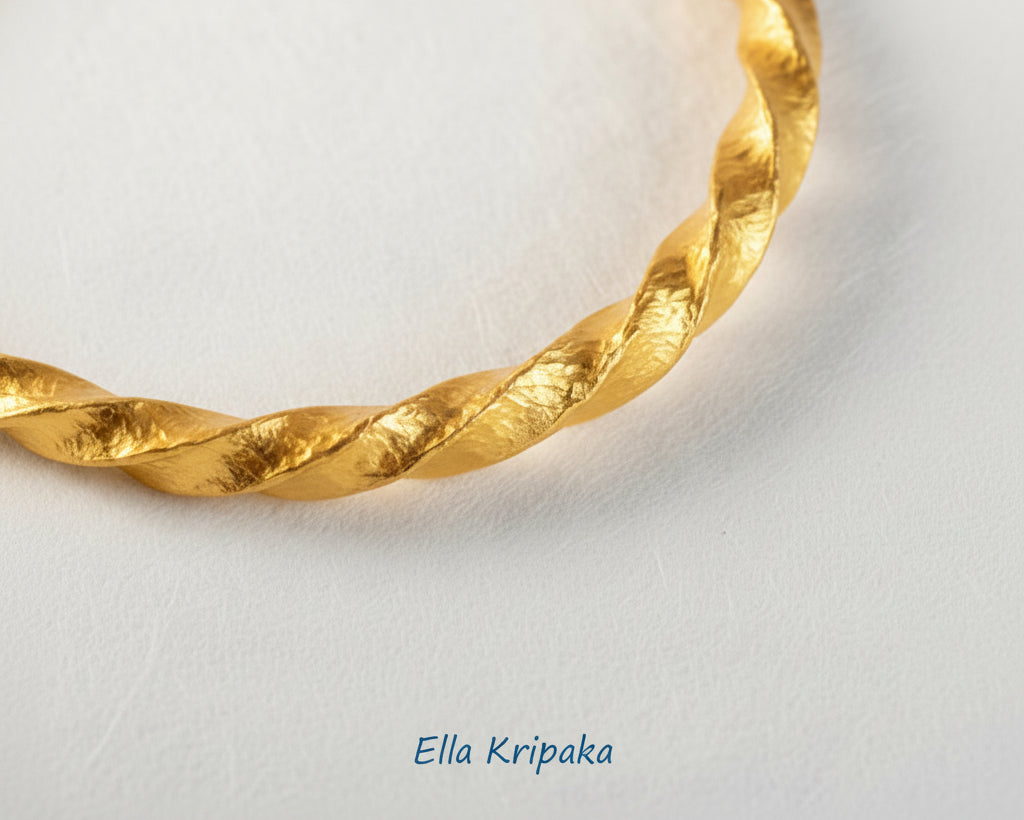 Twisted Viking Hammered 24k 9999 Gold bangle bracelet on white surface, artist's name 'Ella Kripaka' branding