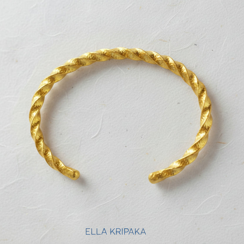 Viking Twisted Hammered 24k 9999 gold cuff thick bracelet on a white background, artist-jeweler name 'Ella Kripaka' branding