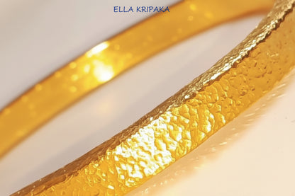Hammered 24k 9999 gold bangle thick bracelet Ancient Rome style on a white background, artist-jeweler name 'Ella Kripaka' branding