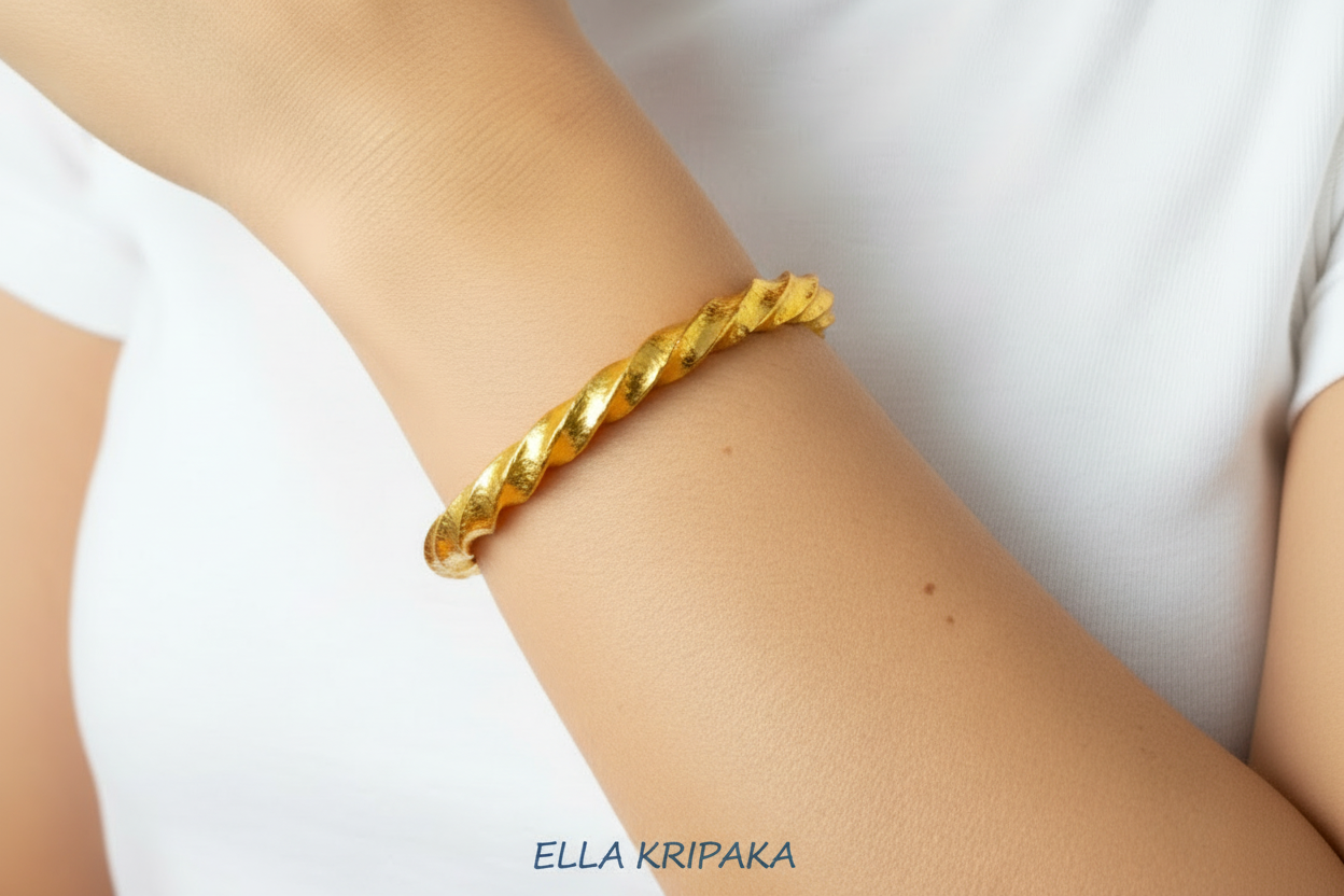 Viking twisted hammered 24k 9999 Gold thick bracelet worn on wrist by a woman and on a white background, and with 'Ella Kripaka' branding