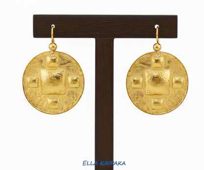 Hammered 24k 9999 Gold Byzantine earrings on a wooden jewelry stand with 'Ella Kripaka' branding
