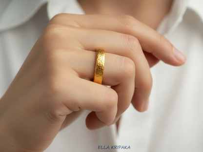 Hammered 24k Gold 9999 gold thick ring band with textured gold worn on model's finger and on a white shirt background, branded 'Ella Kripaka'