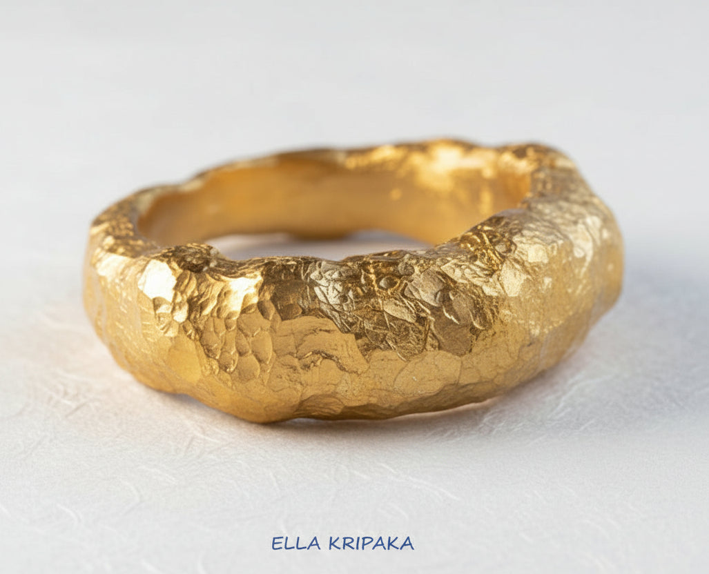 Hammered organic 24k Gold 9999 gold uneven signet thick ring with textured gold on a white craft paper background, branded 'Ella Kripaka'