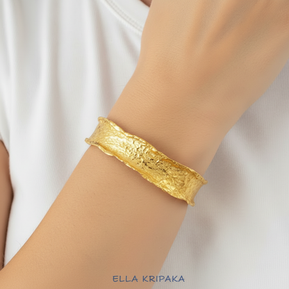 Hammered organic 24k 9999 gold uneven bracelet cuff  on woman's wrist, branding artist-jeweler name 'Ella Kripaka'