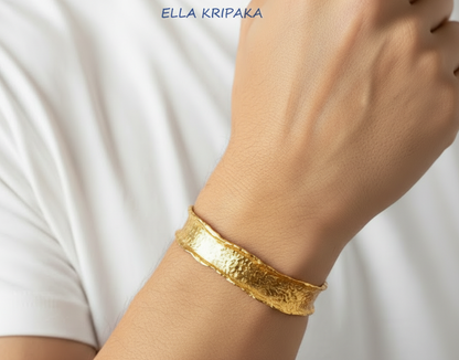 Hammered organic 24k 9999 gold uneven bracelet cuff  on a man's wrist, branding artist-jeweler name 'Ella Kripaka'