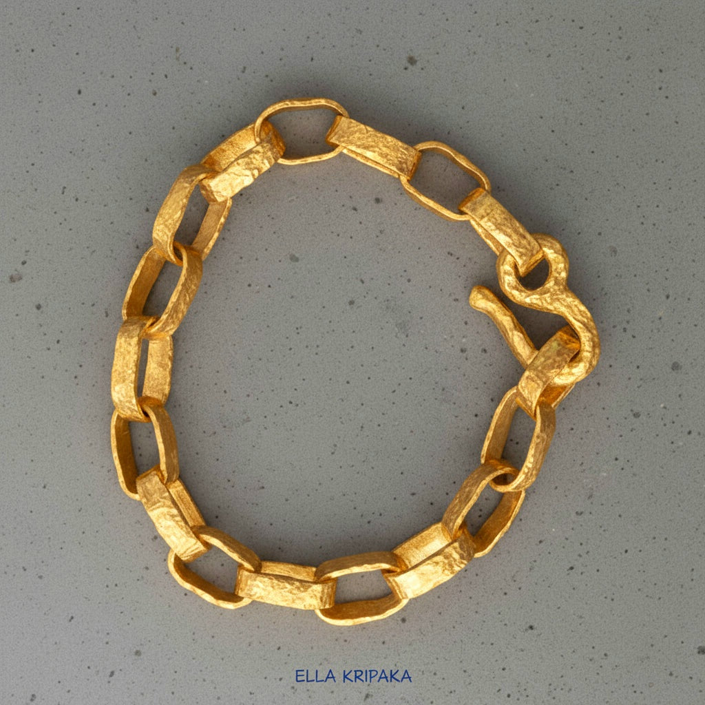 Hammered 24k 9999 gold chain thick bracelet with thick hook clasp Ancient Rome style on a grey background, artist-jeweler name 'Ella Kripaka' branding