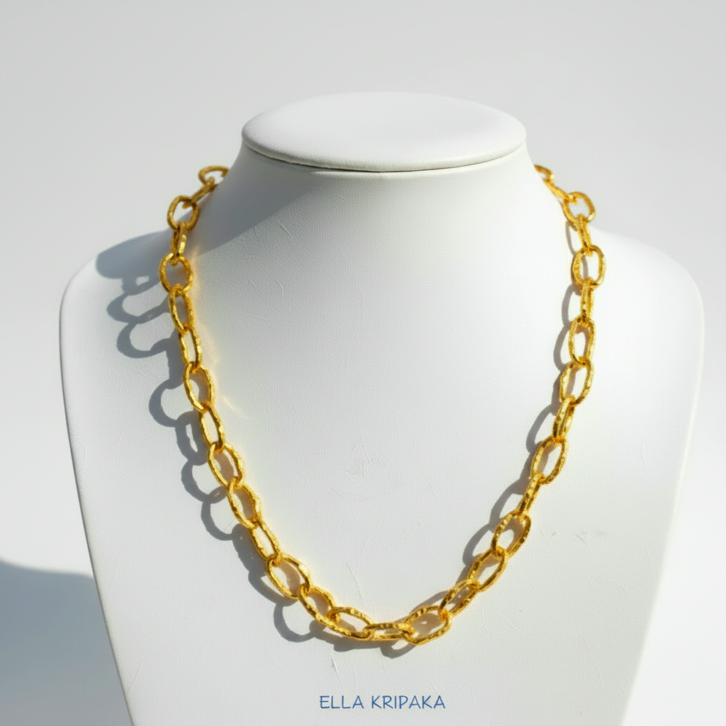 Organic 24k Gold hammered uneven textured chain necklace on a white jewelry stand and on light neutral background, with artist 'Ella Kripaka' branding