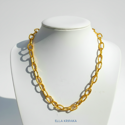 Organic 24k Gold hammered uneven textured chain necklace on a white jewelry stand and on light neutral background, with artist 'Ella Kripaka' branding