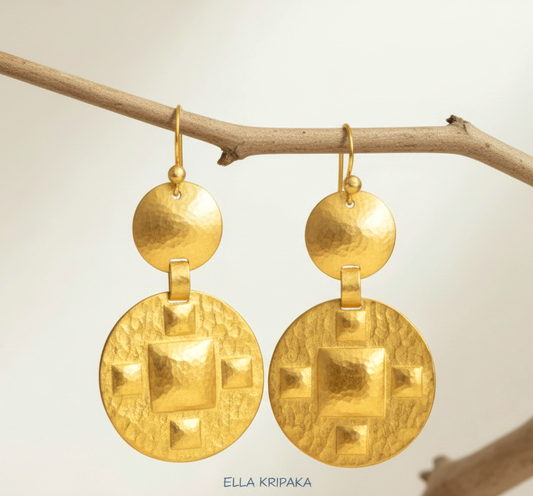 Solid 24k 9999 gold hammered Byzantine earrings with hook clasps and shiny forged gold textures hanging on a branch, artist's name 'ELLA KRIPAKA'