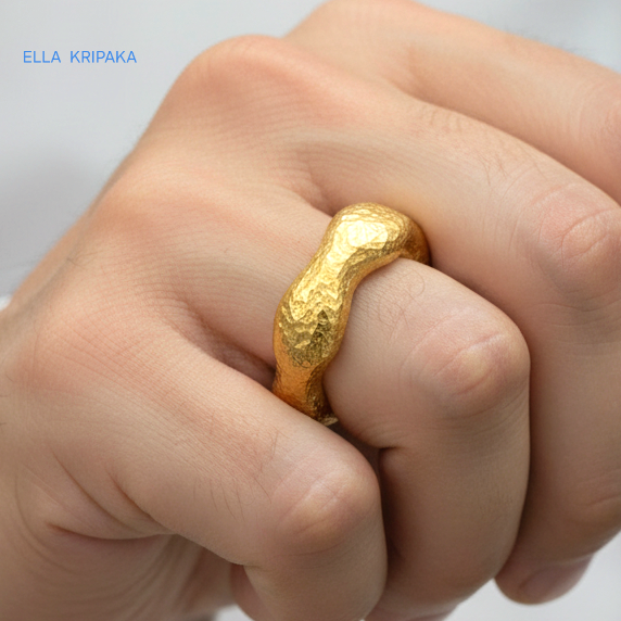 Hammered 24k 9999 Gold thick uneven wavy ring organic with a textured gold surface worn on man's finger and on a blurred white background, branded 'Ella Kripaka'
