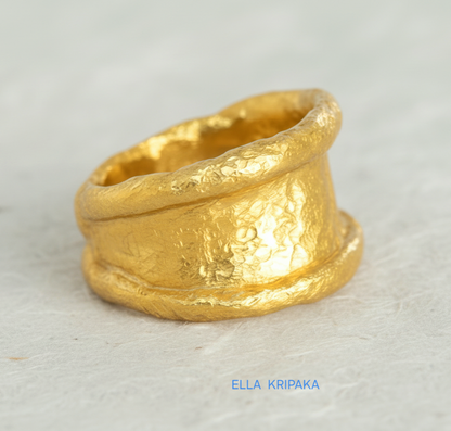 Organic hammered 24k Gold 9999 gold ring signet with thick edges and with textured surface on a white paper background, branded 'Ella Kripaka'