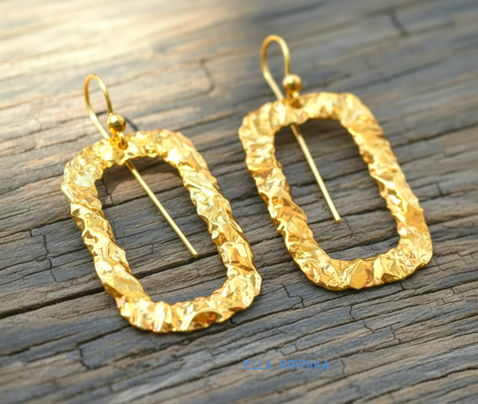 Organic hammered uneven 24k 9999 Gold hoops earrings on a old wooden surface, and with 'ELLA KRIPAKA' branding