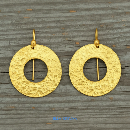 24k 9999 gold hammered hoops earrings Ancient Rome style with shiny gold textures are on old wooden background, artist-jeweler's name 'Ella Kripaka'