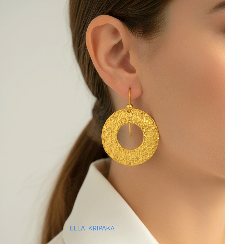 24k 9999 gold hammered hoops Ancient Rome style earrings with shiny gold textures worn by a woman, artist-jeweler's name 'Ella Kripaka'