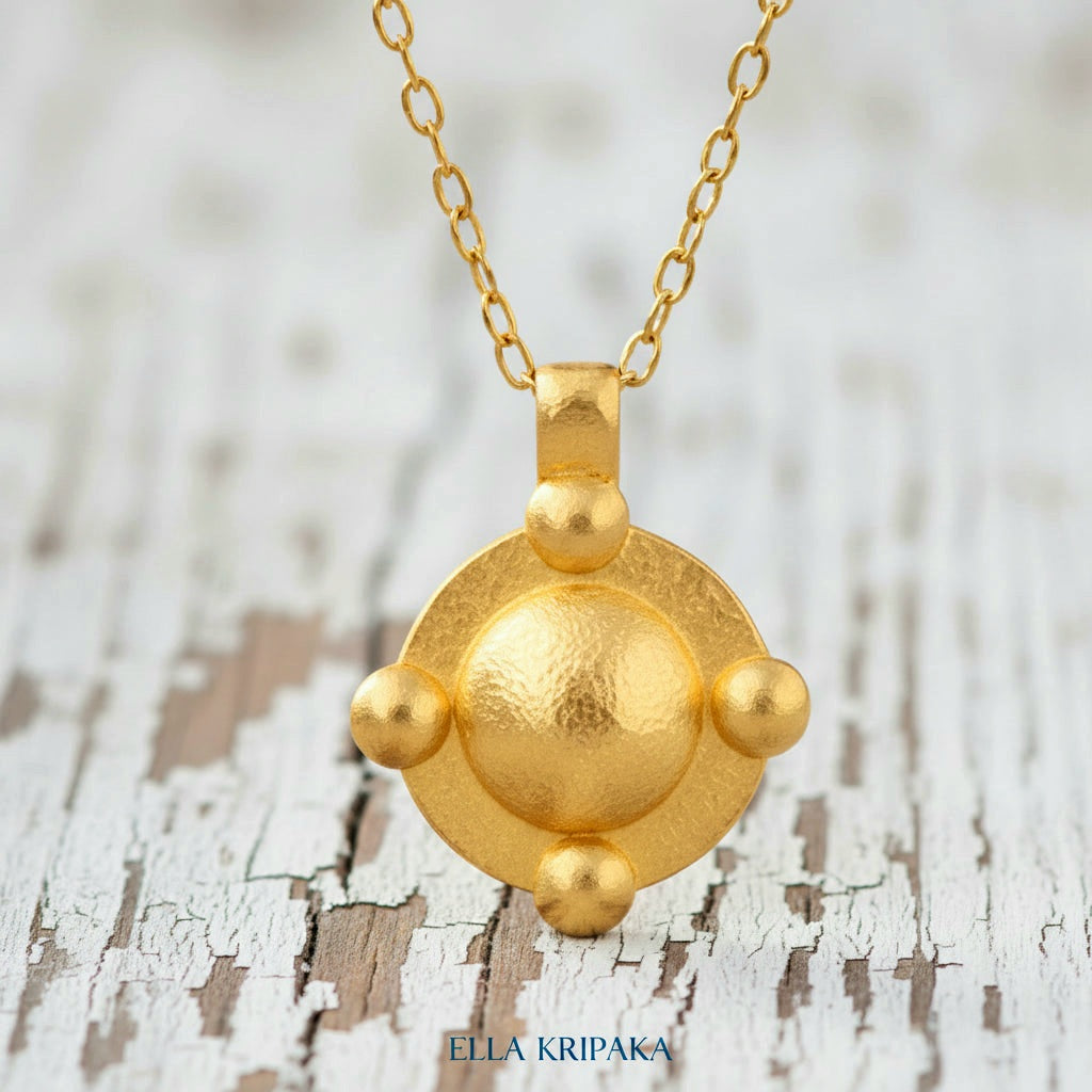 24k gold hammered dome disk with convex rounds textured pendant with chain on white old wooden background, artist 'Ella Kripaka' branding
