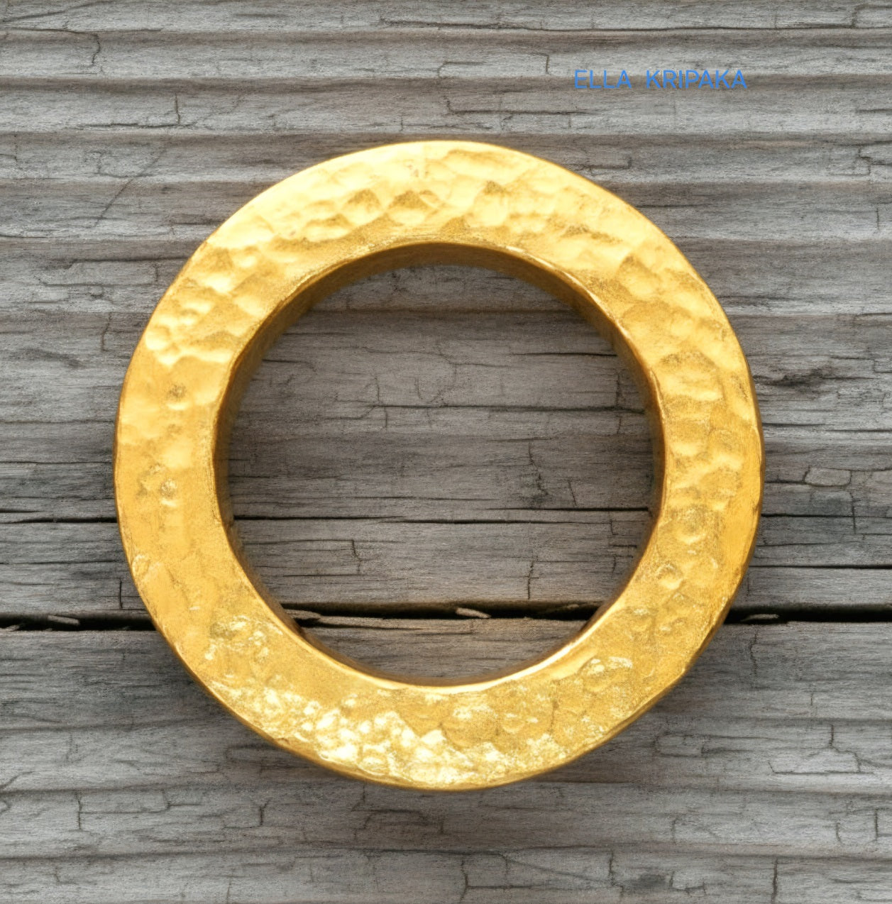 Hammered 24k Gold 9999 gold Ancient Rome  thick ring with textured forged gold on a grey old wooden background, branded artist-jeweler's name 'Ella Kripaka'