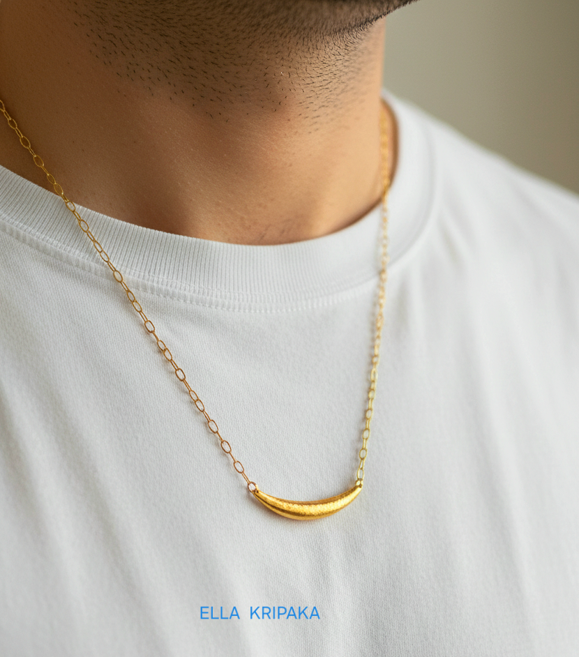 Hammered 24k gold convex Moon pendant with chain worn by a man and with a white blurred background with 'Ella Kripaka' branding