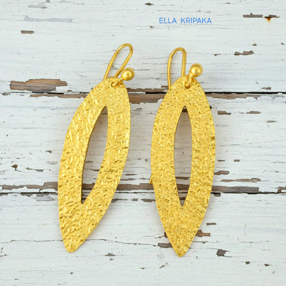 Hammered 24k 9999 Gold Byzantine leaf earrings on a old white wooden background with 'Ella Kripaka' branding