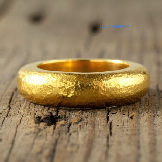 Hammered 24k Gold 9999 gold Ancient Rome  thick ring with textured forged gold on a grey old wooden background, branded artist-jeweler's name 'Ella Kripaka'