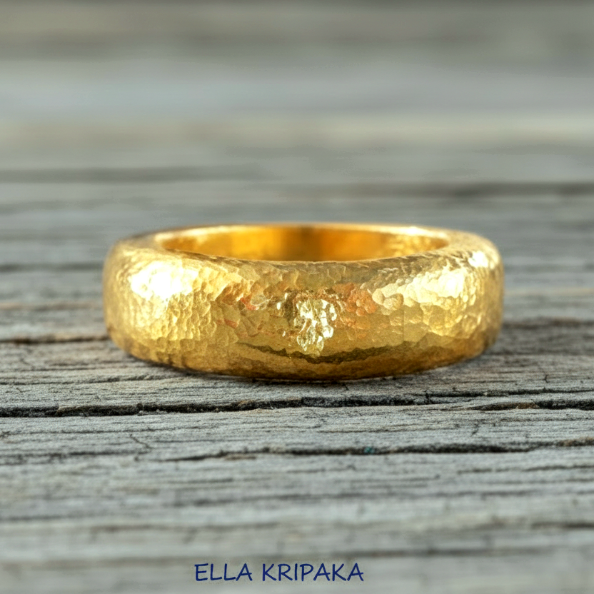 Hammered 24k Gold 9999 gold Ancient Rome  thick ring with textured forged gold on a grey old wooden background, branded 'Ella Kripaka'