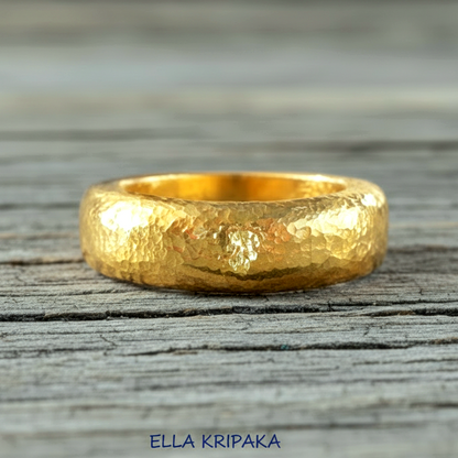 Hammered 24k Gold 9999 gold Ancient Rome  thick ring with textured forged gold on a grey old wooden background, branded 'Ella Kripaka'