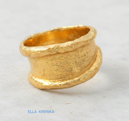 Organic hammered 24k Gold 9999 gold ring signet with thick edges and with textured surface on a white paper background, branded 'Ella Kripaka'
