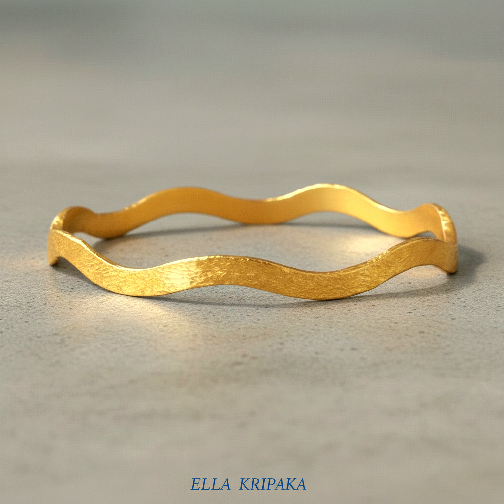 24k gold hammered bracelet bangle with wavy design on grey concrete background, branded 'Ella Kripaka'