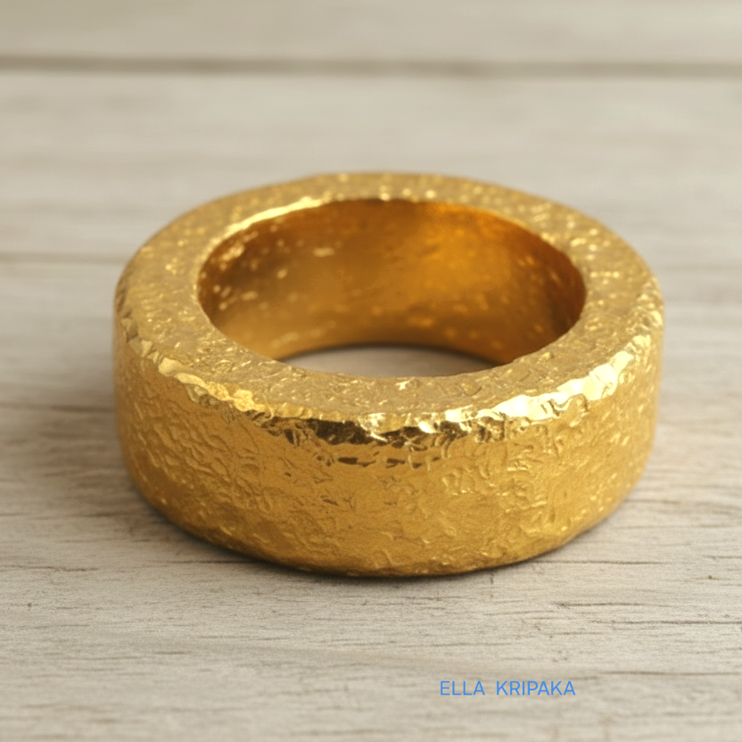 Hammered 24k 9999 Gold thick ring Ancient Rome style with a textured forged gold surface on a old wooden background, branded 'Ella Kripaka'