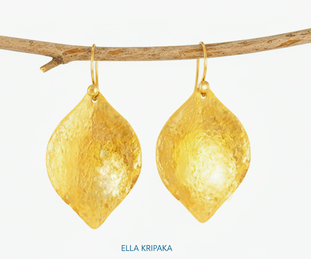 Hammered 24k 9999 Gold convex leaf earrings Ancient Rome and Byzantine style hanging on thin branch on a white background, and artist-jeweler's name 'Ella Kripaka' branding