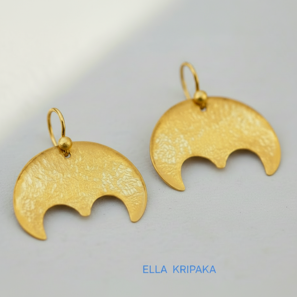 Hammered 24k 9999 Gold convex Moon earrings Ancient Rome and Byzantine style on a old wooden background, and artist-jeweler's name 'Ella Kripaka' branding